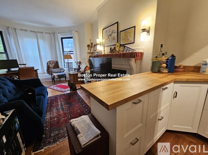 A living room with a blue couch and a wooden countertop.