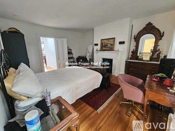 A bedroom with a bed, chair, and a dresser.
