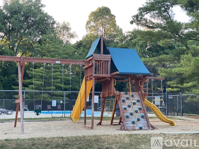 A playground with a blue roof and a yellow slide.