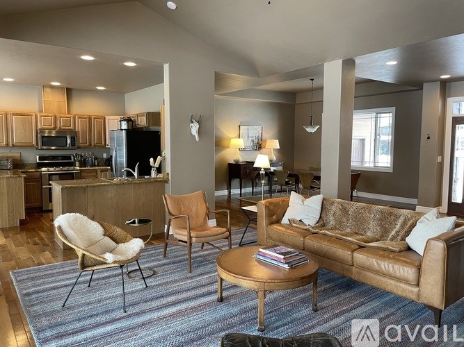A living room with a couch, chair, and coffee table.