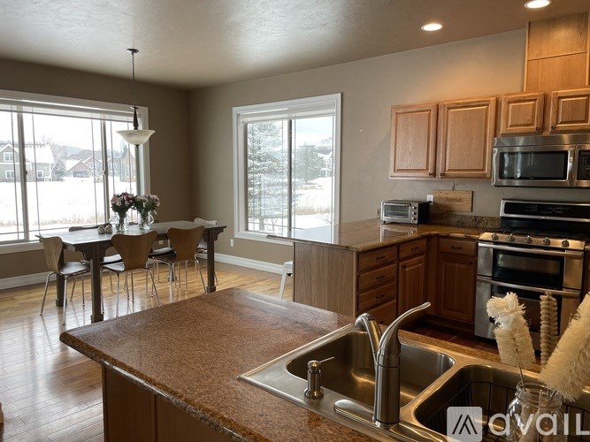 A kitchen with a brown countertop and stainless steel appliances.