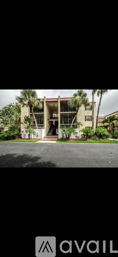 A building with a palm tree in front of it.