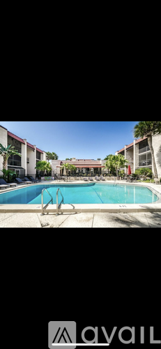 A pool with a diving board in the middle of it.