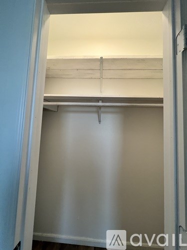 A white closet with a hanging rod.
