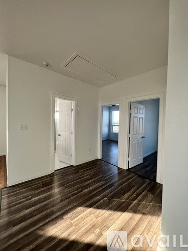 A room with wooden floors and white walls.