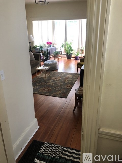A living room with a rug on the floor and a couch.