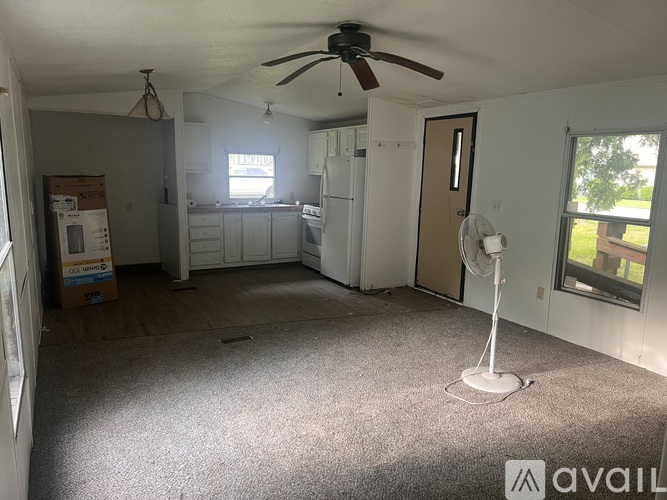A room with a fan and a window.