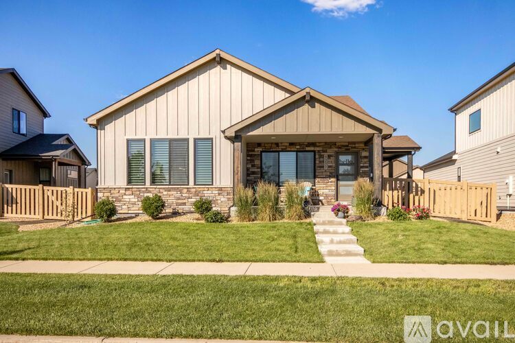 A house with a front yard and a clear sky.