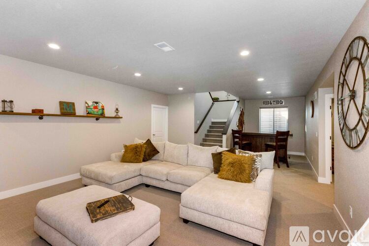 A living room with a white couch and a wooden coffee table.
