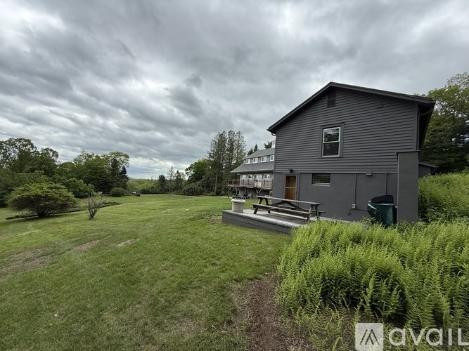A house with a grey roof and a green lawn in front.