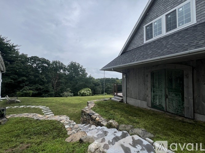 A house with a stone pathway leading to the front door.