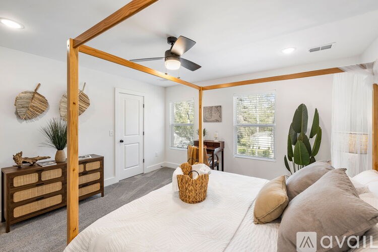 A bedroom with a large bed and a wooden frame.