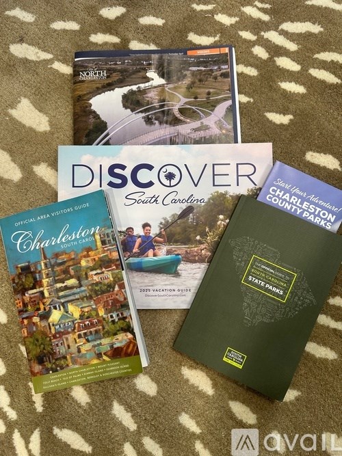 A collection of travel guides including one for South Carolina and Charleston.