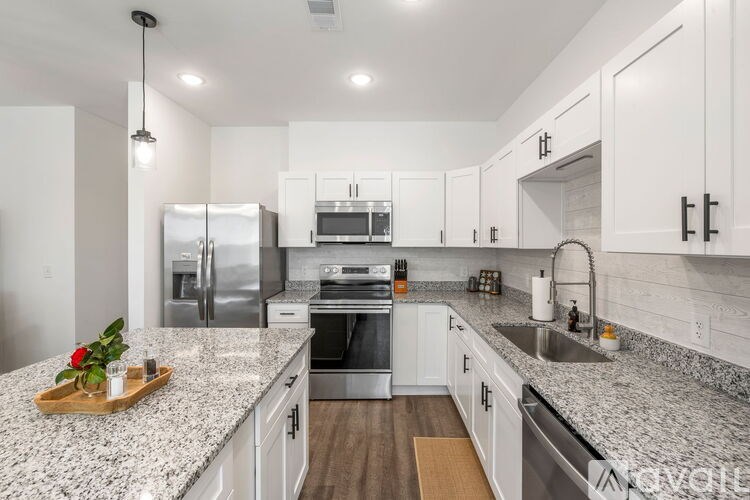 A kitchen with granite countertops and stainless steel appliances.