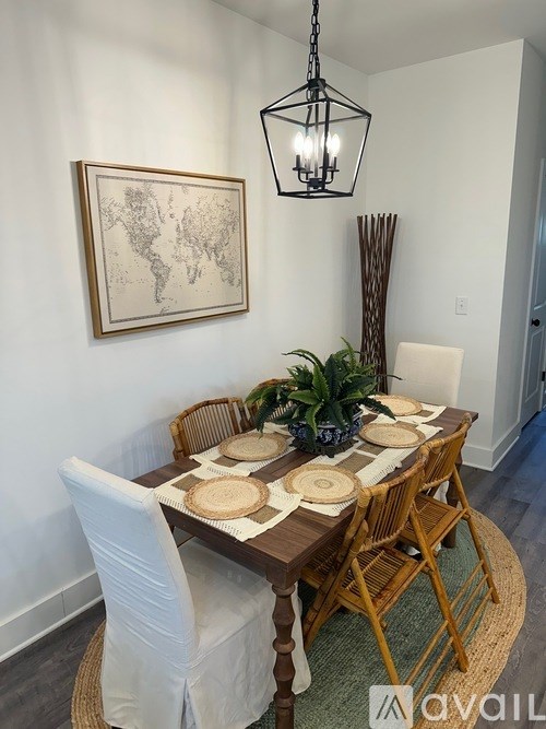 A dining table set with plates and a potted plant.