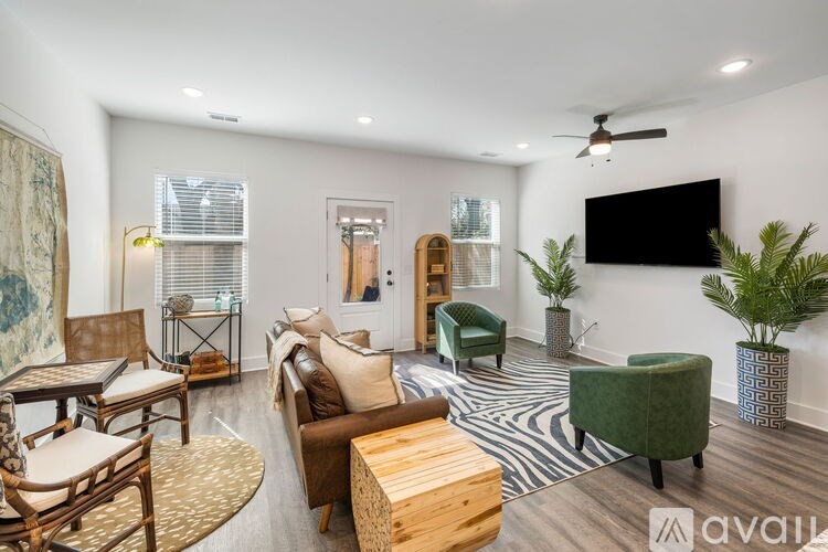 A living room with a variety of furniture including a couch, armchair, and coffee table.