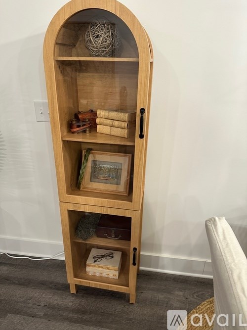 A wooden shelf with various items on it.