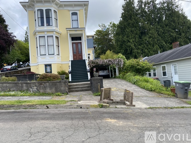 A two-story house with a car parked in front.