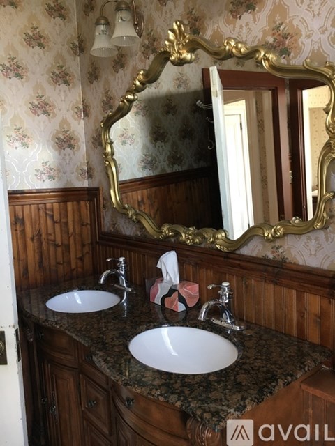 A room with a large window and a chandelier.