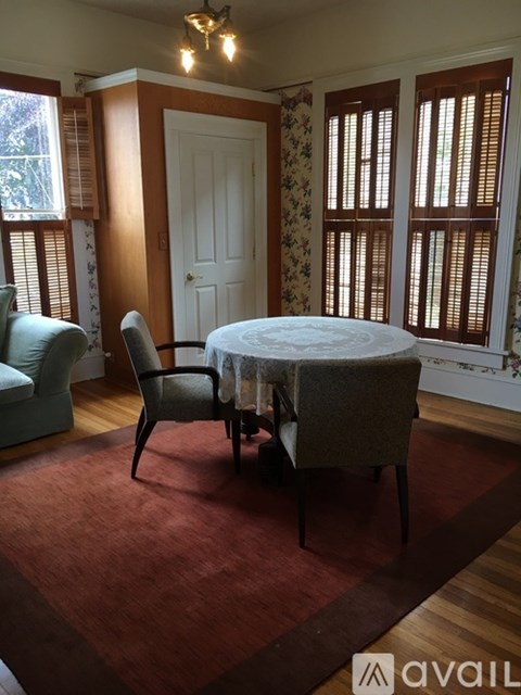 A living room with floral wallpaper and furniture from North Coast Rentals, LLC.