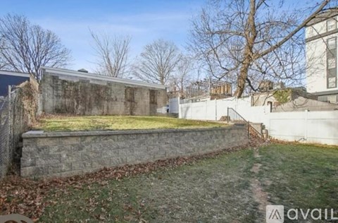 A stone wall with a grassy area in front of it.