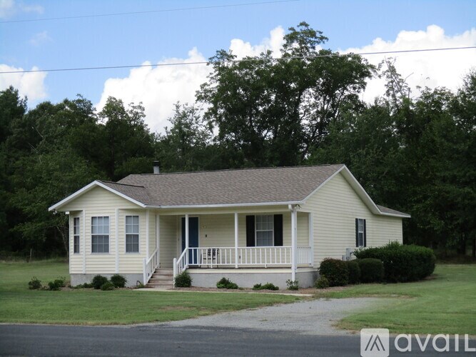 A house with a porch and a front yard.
