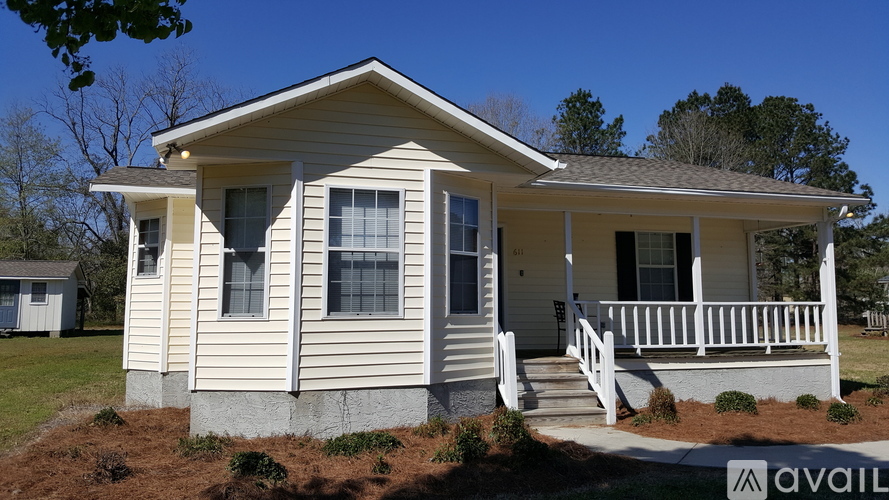 A house with a porch and a small front yard.