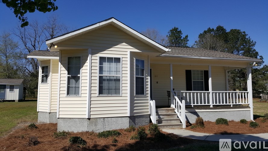A house with a porch and a small front yard.