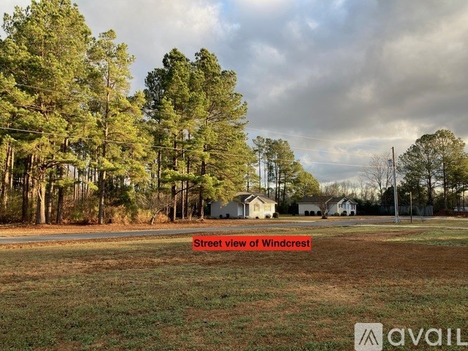 A white toilet sits next to a bathtub in a bathroom.