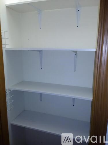Empty white shelves in a room.