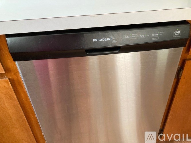 A close up of a stainless steel oven with the brand name FRIGIDAIRE visible on the control panel.