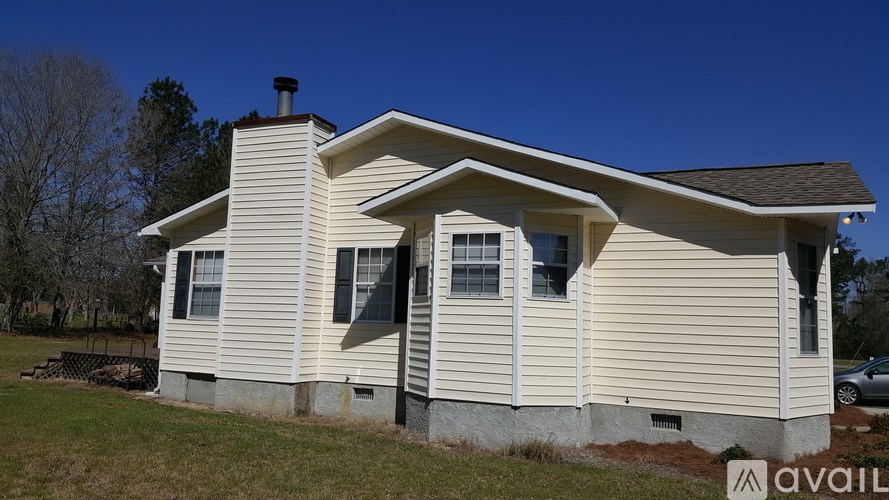 A house with a chimney and a sign that says "available" in the front yard.