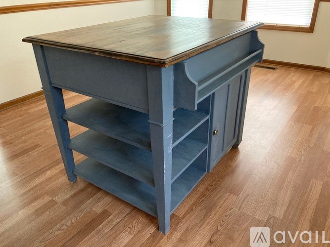 A blue desk with a drawer is available for purchase.