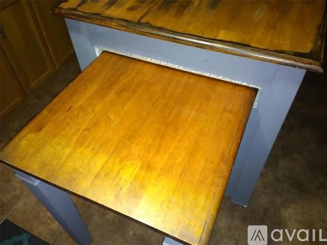 A wooden table with a metal frame is available for purchase.