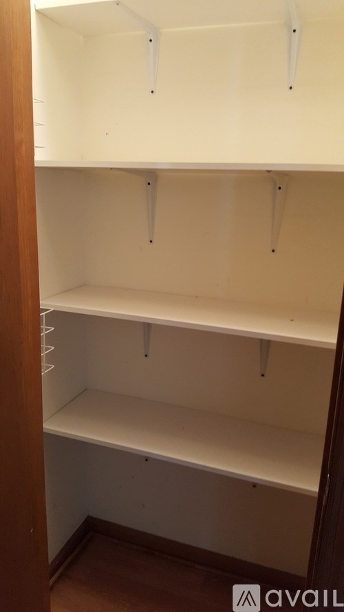 A white shelving unit with three shelves is shown.
