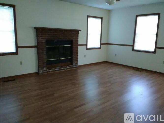 A room with a fireplace and wooden floors.
