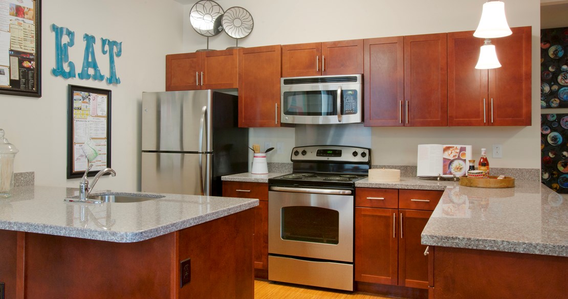 a kitchen with stainless steel appliances and granite counter tops