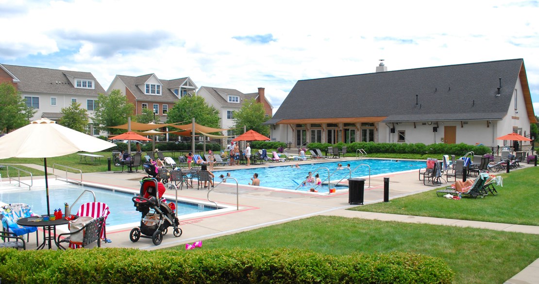 a group of people swimming in a pool at a resort