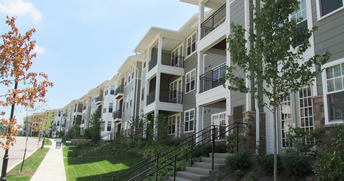 a row of new apartment buildings on a city street