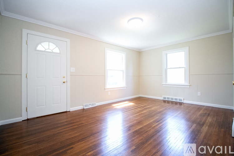 A room with wooden floors and white walls.