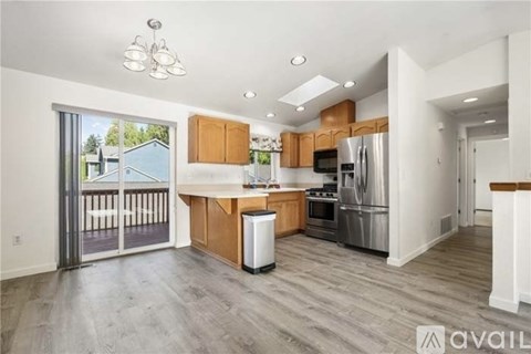 A kitchen with wooden cabinets and a white fridge.