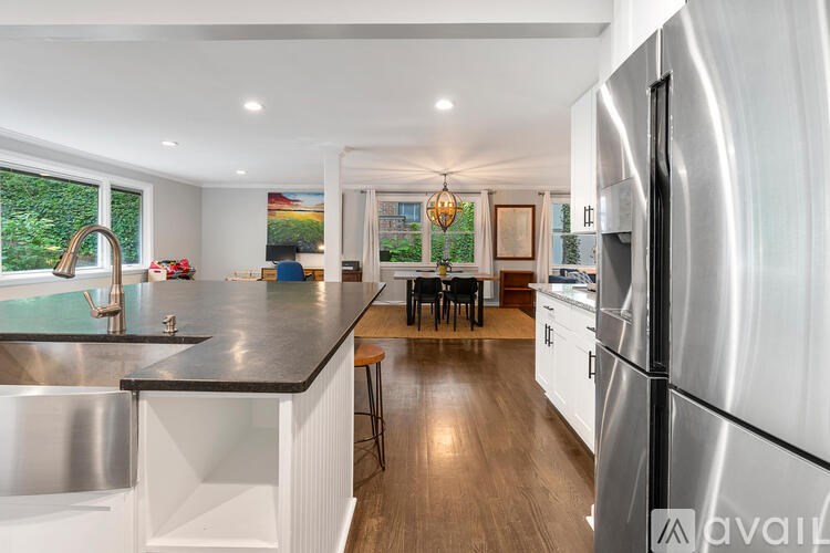 A modern kitchen with a large island and stainless steel appliances.