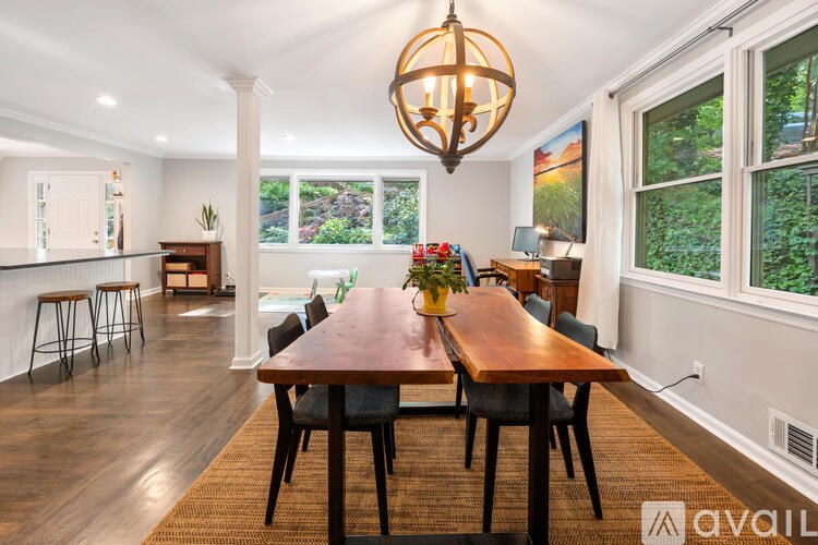 A dining room with a wooden table and chairs.