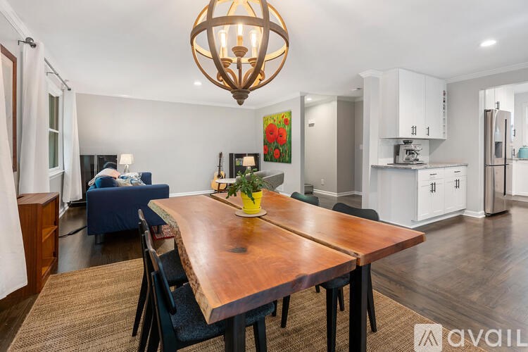 A dining room with a wooden table and chairs.