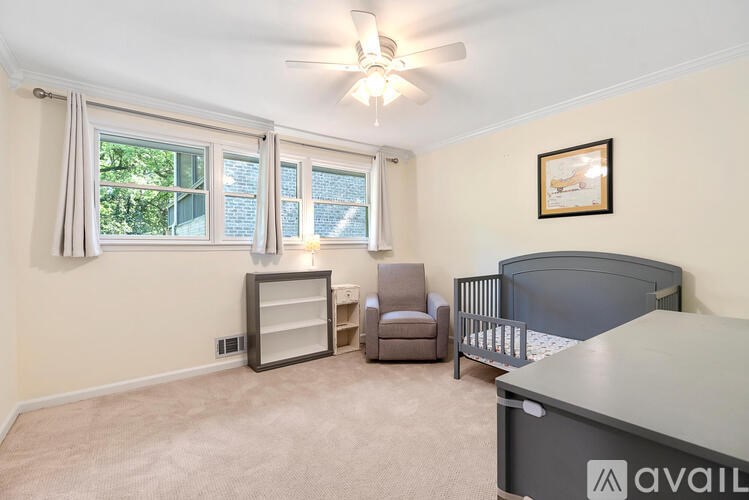 A baby room with a crib and a chair.