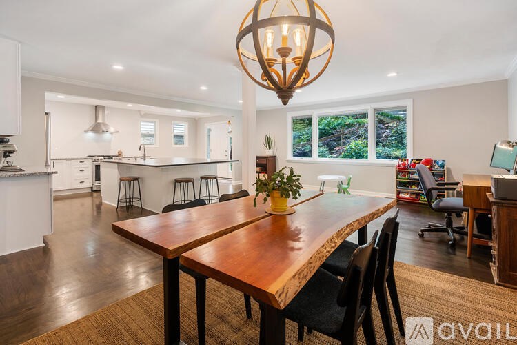 A dining room with a wooden table and chairs.