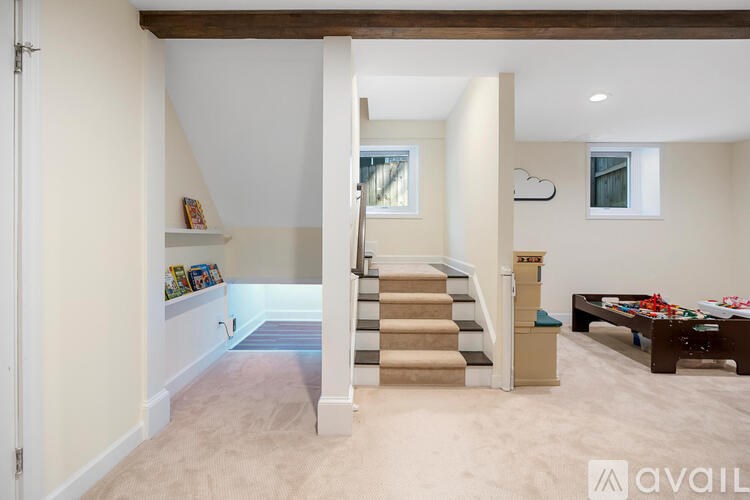A living room with a staircase leading to the upper floor.