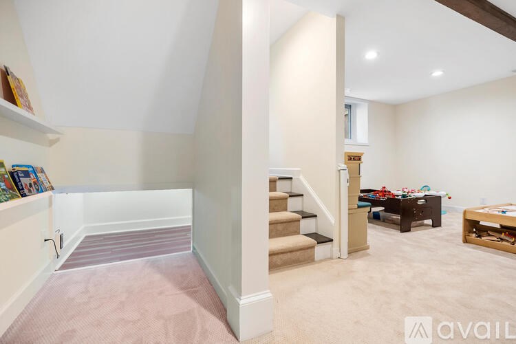 A living room with a staircase leading to the upper floor.