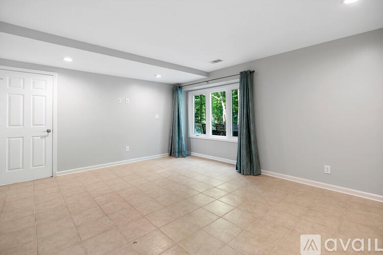 A room with a door, window, and tiled floor.