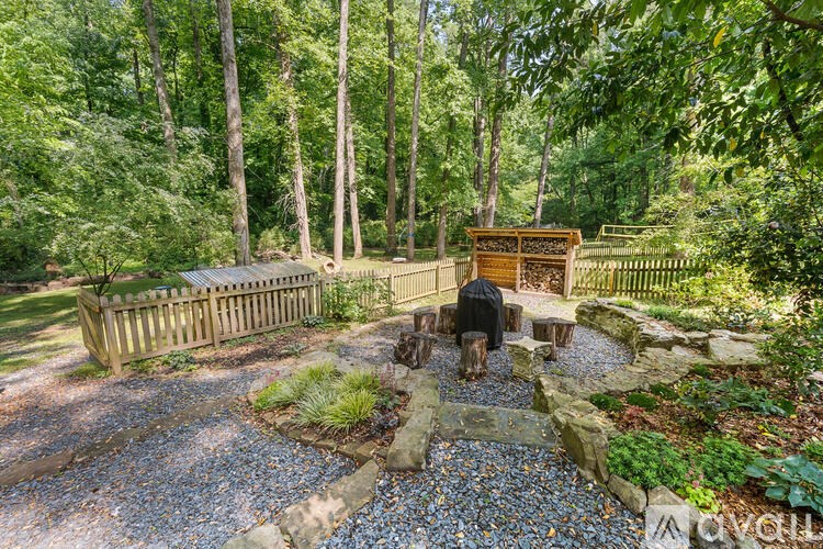 A person is sitting on a wooden bench in a garden.